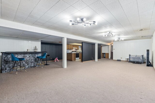 basement with carpet and indoor bar