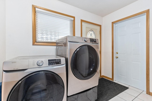 laundry room with light tile patterned floors and independent washer and dryer