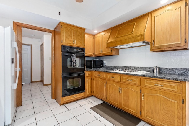 kitchen featuring premium range hood, light tile patterned flooring, and black appliances