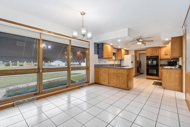 kitchen featuring double oven, light tile patterned floors, decorative light fixtures, dark stone countertops, and white fridge with ice dispenser