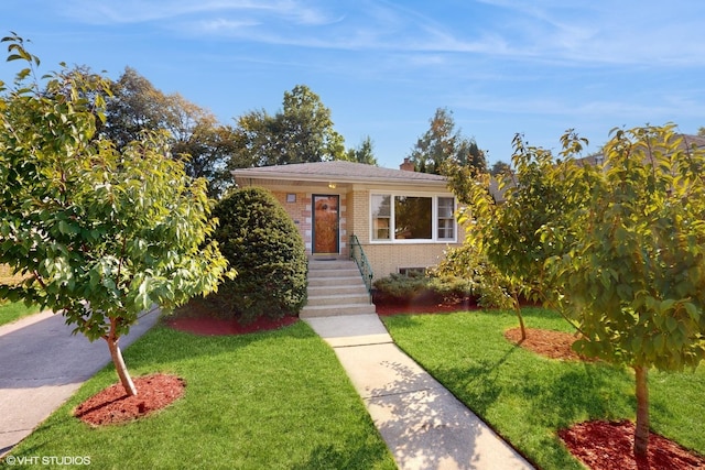 bungalow-style home with brick siding, a chimney, and a front lawn