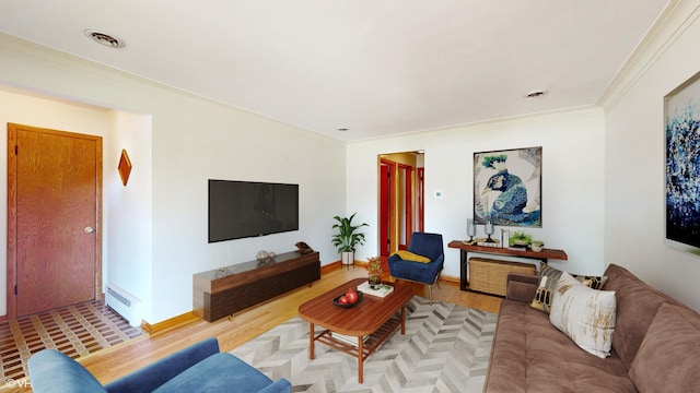 living room featuring visible vents, crown molding, baseboards, wood finished floors, and a baseboard radiator