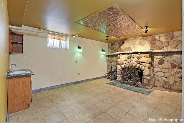 living room with a fireplace and sink