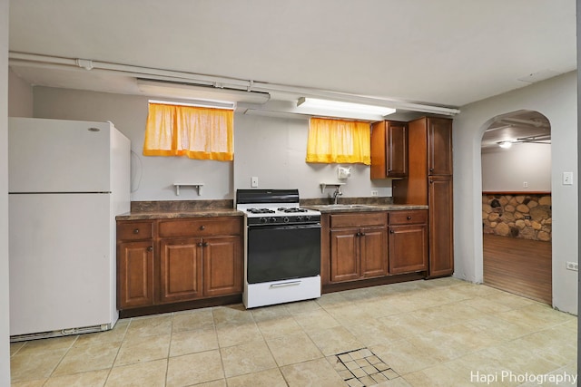 kitchen with sink and white appliances