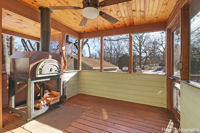 sunroom with ceiling fan, plenty of natural light, and wood ceiling