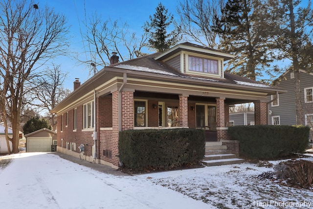 bungalow-style house with an outbuilding, covered porch, and a garage