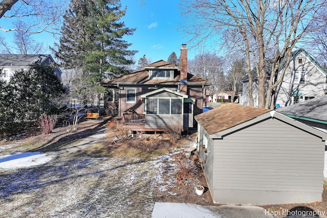 rear view of property with a sunroom