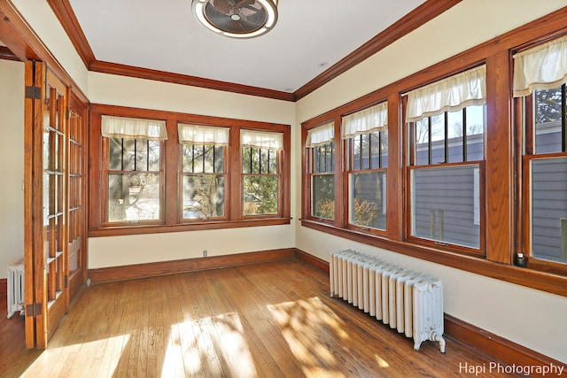 unfurnished sunroom featuring radiator