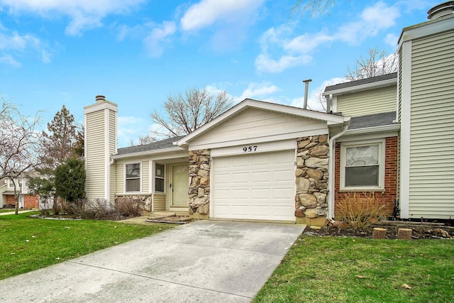 view of front facade with a garage and a front lawn