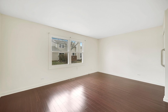 empty room with dark hardwood / wood-style floors