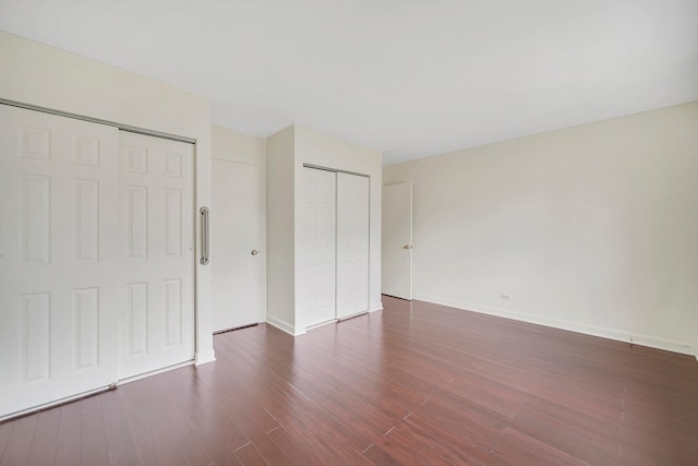 unfurnished bedroom with dark hardwood / wood-style floors