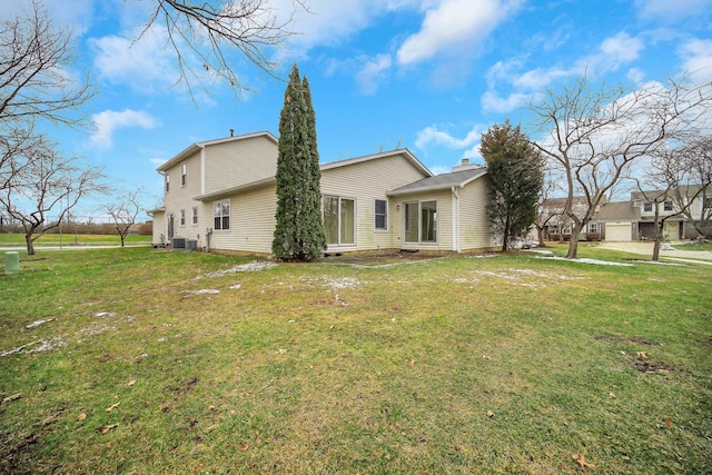 exterior space featuring a lawn and central AC unit