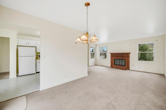 unfurnished living room featuring light colored carpet and a chandelier