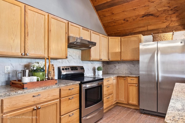 kitchen featuring tasteful backsplash, light stone countertops, lofted ceiling, and appliances with stainless steel finishes