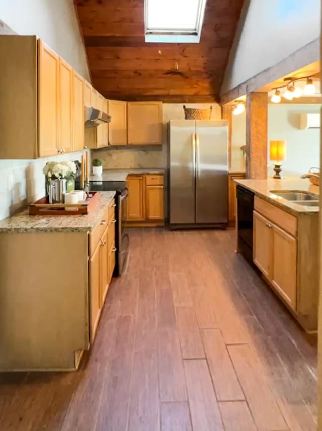 kitchen with appliances with stainless steel finishes, vaulted ceiling with skylight, wood ceiling, and sink