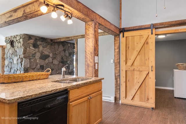 kitchen featuring sink, dark hardwood / wood-style floors, a barn door, black dishwasher, and light stone counters