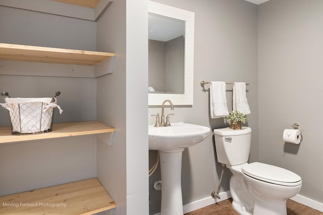 bathroom featuring hardwood / wood-style flooring, sink, and toilet