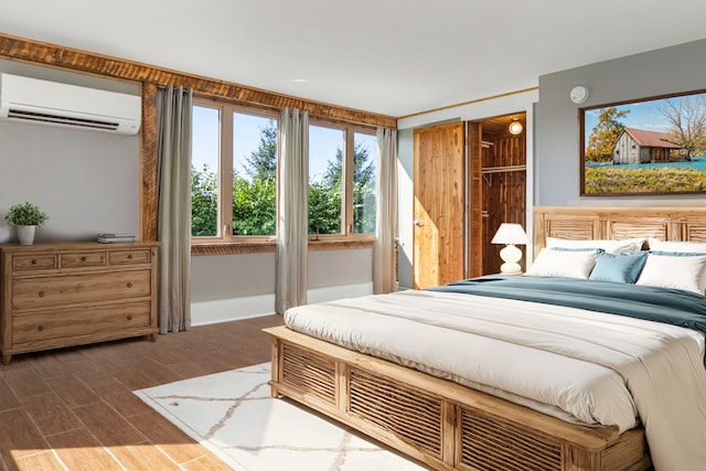 bedroom with a wall mounted air conditioner and dark hardwood / wood-style floors