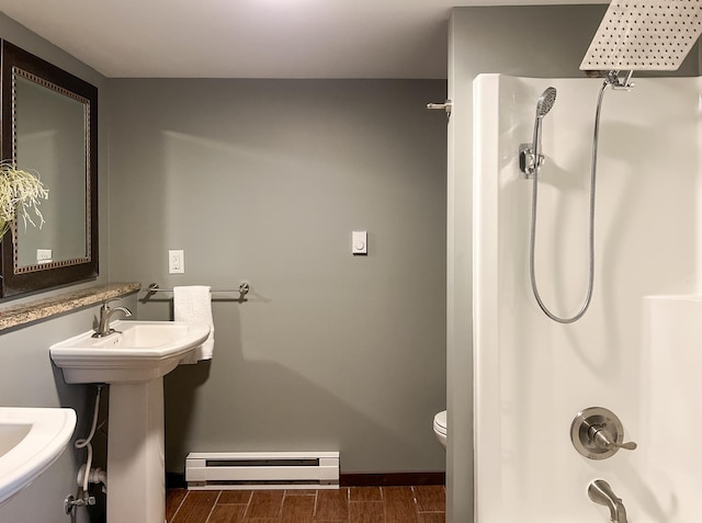 bathroom with a baseboard radiator and toilet