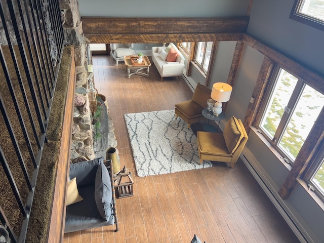 living room featuring a baseboard heating unit and hardwood / wood-style flooring