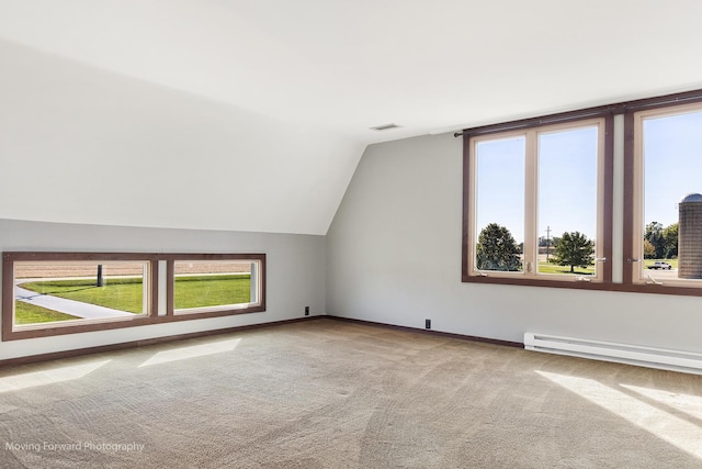 additional living space featuring carpet floors, a baseboard radiator, and vaulted ceiling