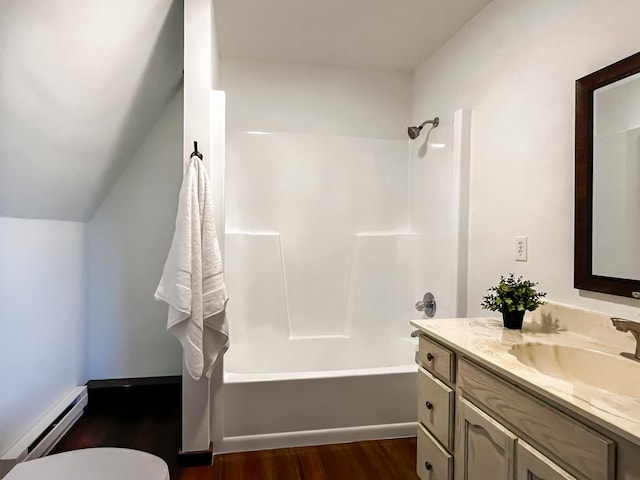 bathroom featuring shower / bathtub combination, vanity, vaulted ceiling, a baseboard heating unit, and hardwood / wood-style floors