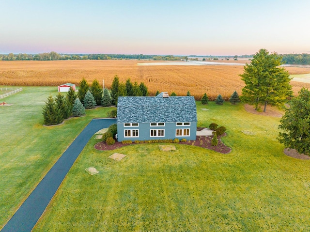 aerial view at dusk featuring a rural view