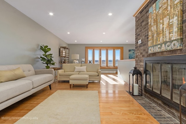 living room featuring wood-type flooring and a fireplace