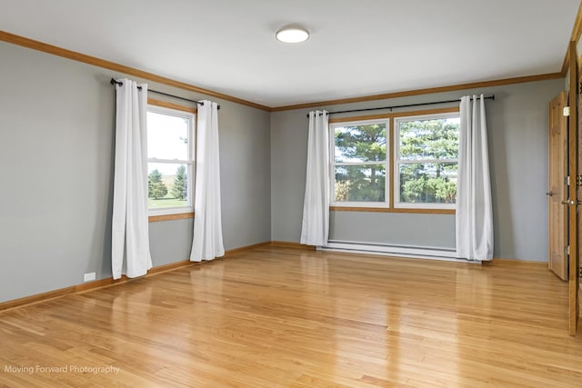 spare room with light hardwood / wood-style floors, a baseboard radiator, and ornamental molding