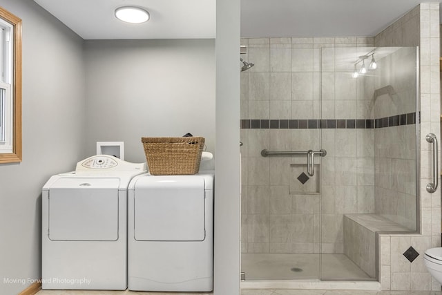 bathroom featuring washing machine and dryer, toilet, and walk in shower