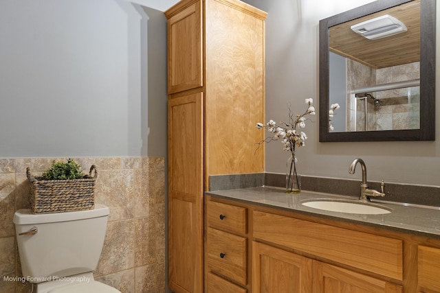 bathroom with vanity, toilet, and an enclosed shower