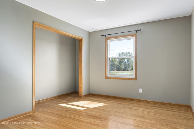 unfurnished bedroom with a closet and light hardwood / wood-style flooring