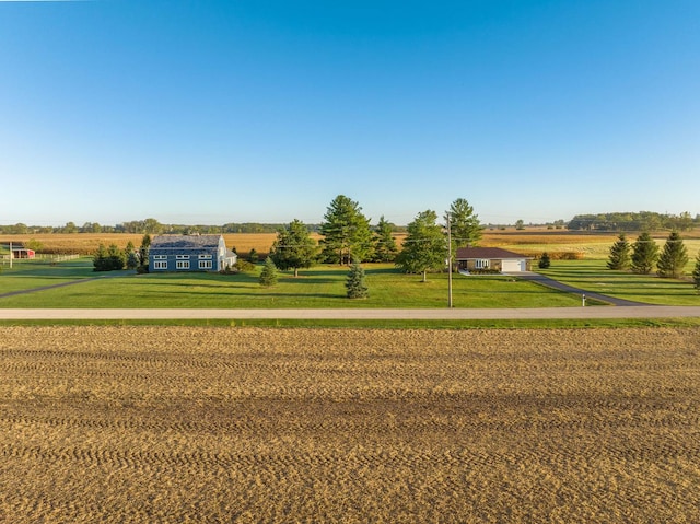 surrounding community featuring a lawn and a rural view