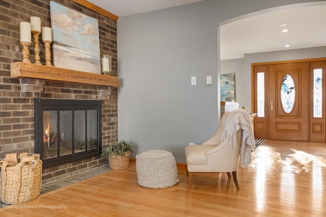 foyer entrance with a fireplace and light hardwood / wood-style floors