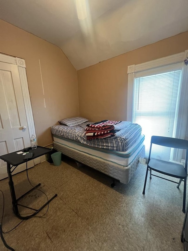 bedroom with ceiling fan and lofted ceiling