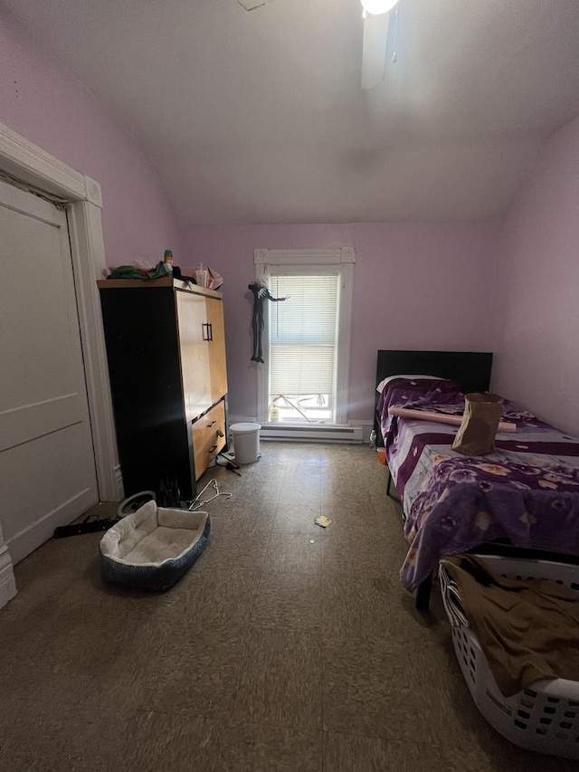 bedroom featuring lofted ceiling, ceiling fan, and a baseboard heating unit