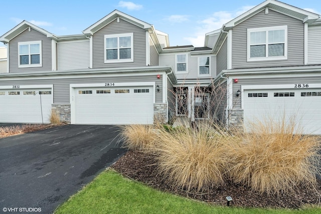 townhome / multi-family property featuring a garage