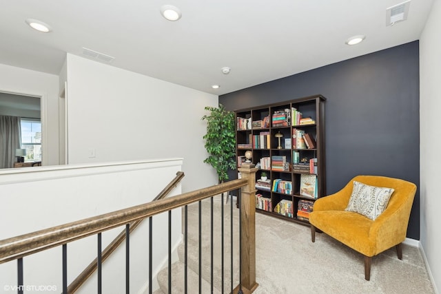 living area featuring light carpet