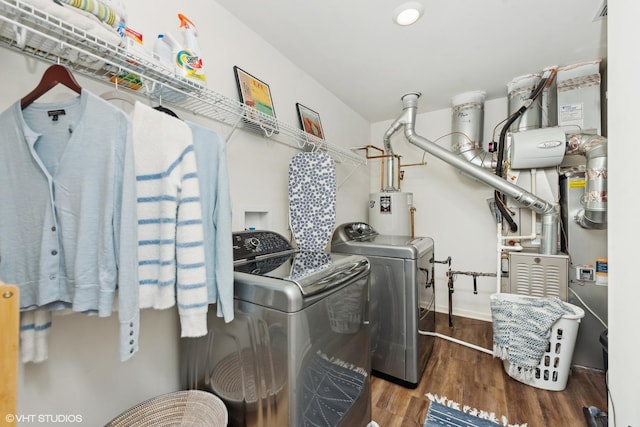 washroom featuring water heater, dark wood-type flooring, and independent washer and dryer