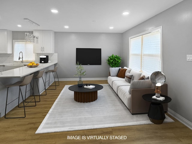 living room with a wealth of natural light and light hardwood / wood-style floors