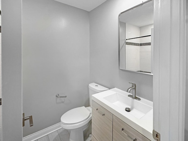 bathroom with vanity, a shower, and toilet