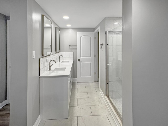 bathroom with walk in shower and vanity