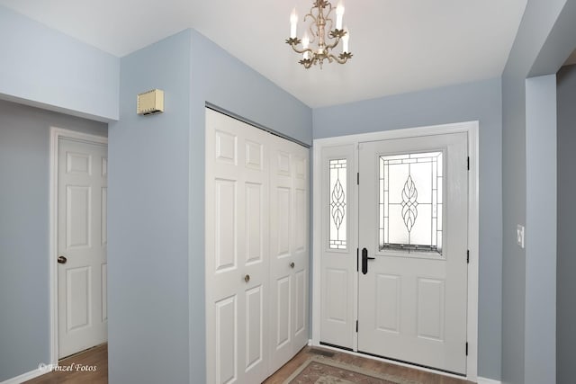 foyer with a chandelier and hardwood / wood-style flooring