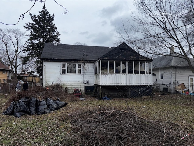 back of house featuring a sunroom