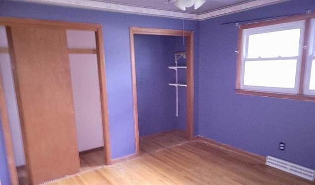 unfurnished bedroom featuring a closet and wood-type flooring