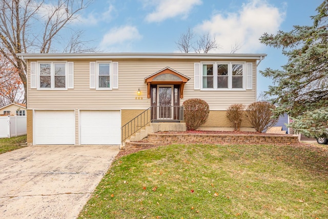 bi-level home with a garage and a front yard