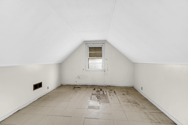 additional living space featuring vaulted ceiling