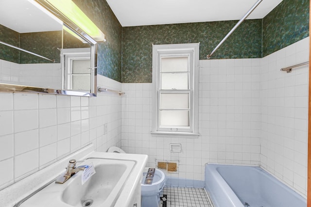 full bathroom with sink, tub / shower combination, tile patterned floors, toilet, and tile walls