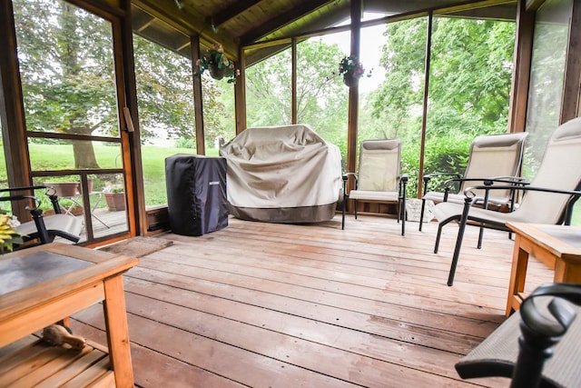 sunroom featuring vaulted ceiling and wood ceiling