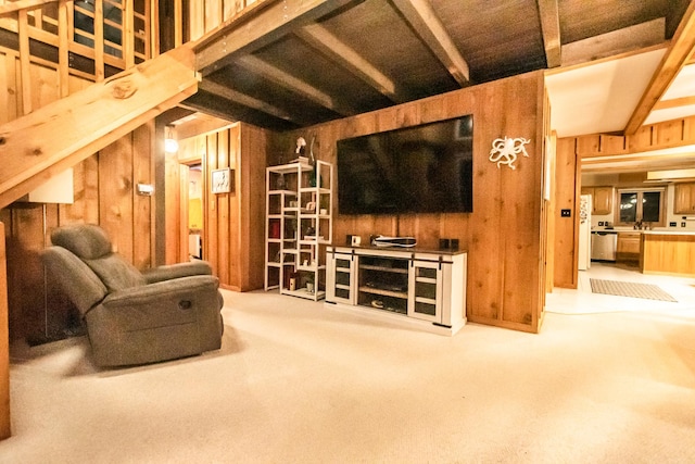 living room with beamed ceiling, carpet flooring, and wood walls